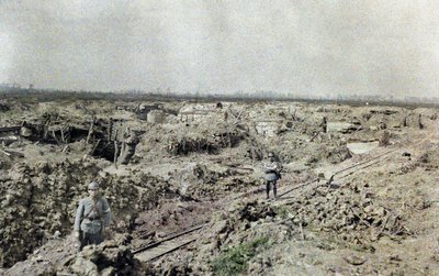 Two French soldiers standing at a narrow gauge railroad track near the French line at Het Sas in an area devastated by artillery fire, Belgium, September 10, 1917 by Paul Castelnau